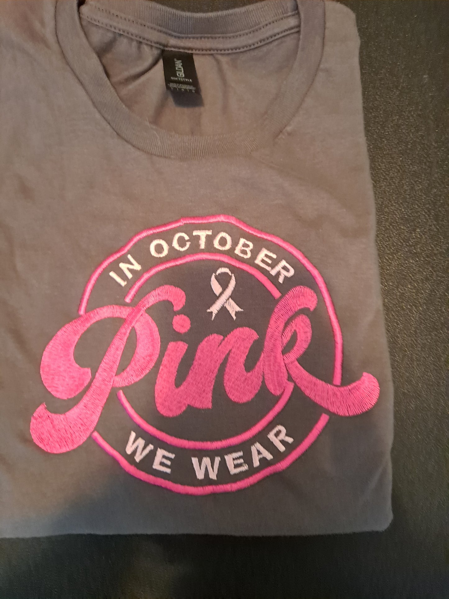 In October We Wear Pink embroidered on T Shirt