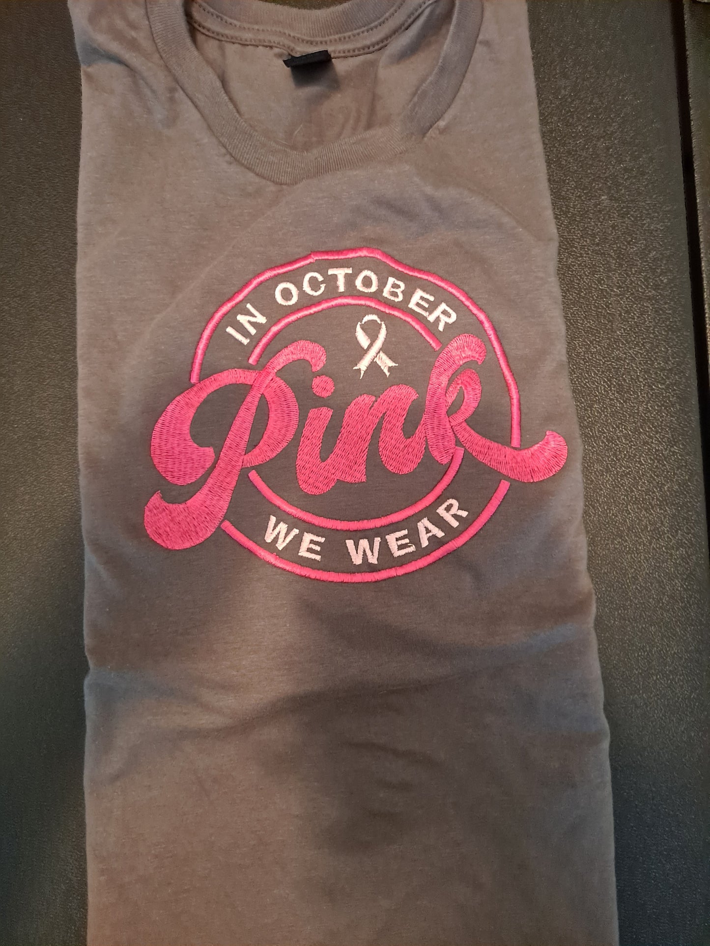 In October We Wear Pink embroidered on T Shirt